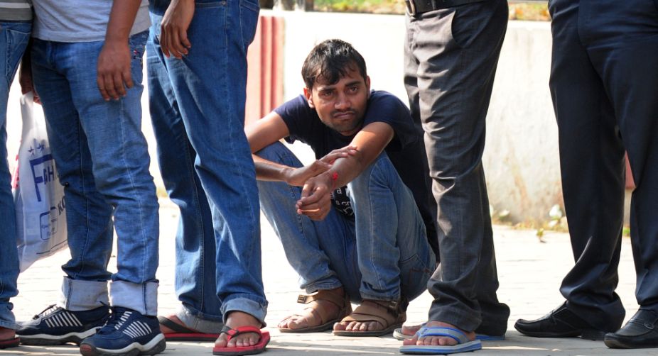 Too tired to stand at a queue in an Allahabad ATM. <span> People queued outside banks to replace Rs.500 and Rs.1,000 currency notes after Prime Minister Narendra Modi announced they would no longer be legal tender in a blitz against corruption and tax evasion</span> (PHOTO: <span>SANJAY KANOJIA / AFP)</span> img
