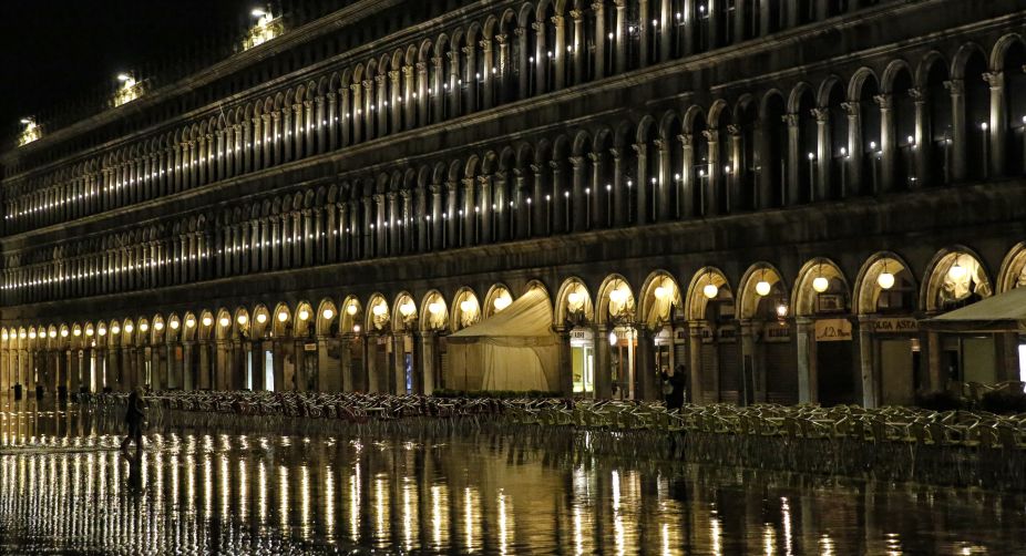 <div>Tourists walk in the flooded St Mark's square during a night of acqua-alta or high-water in Venice, northern Italy (Photo: Marco Bertorello/AFP)</div><div>A picture taken shows the reflection of policemen in the front door of the Bataclan Cafe in Paris (Photo: Joel Saget/AFP)</div> img