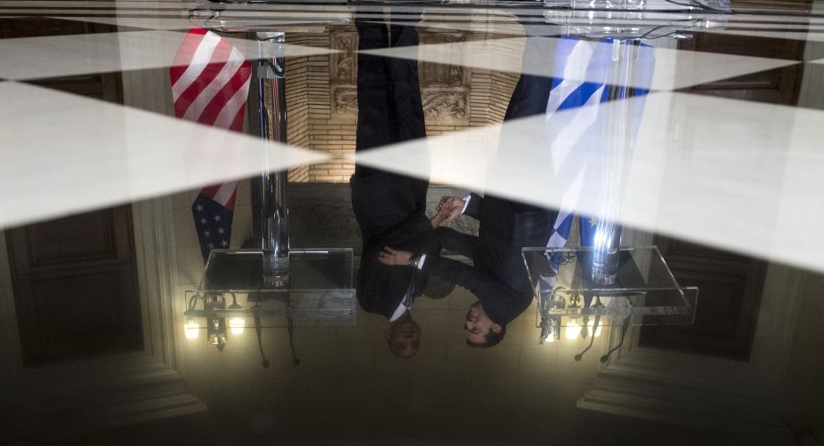 US President Barack Obama and Greek Prime Minister Alexis Tsipras are reflected in the tiles of the Maximos Mansion in Athens during a press conference after their meeting (Photo: Brendan Smialowski/AFP) img