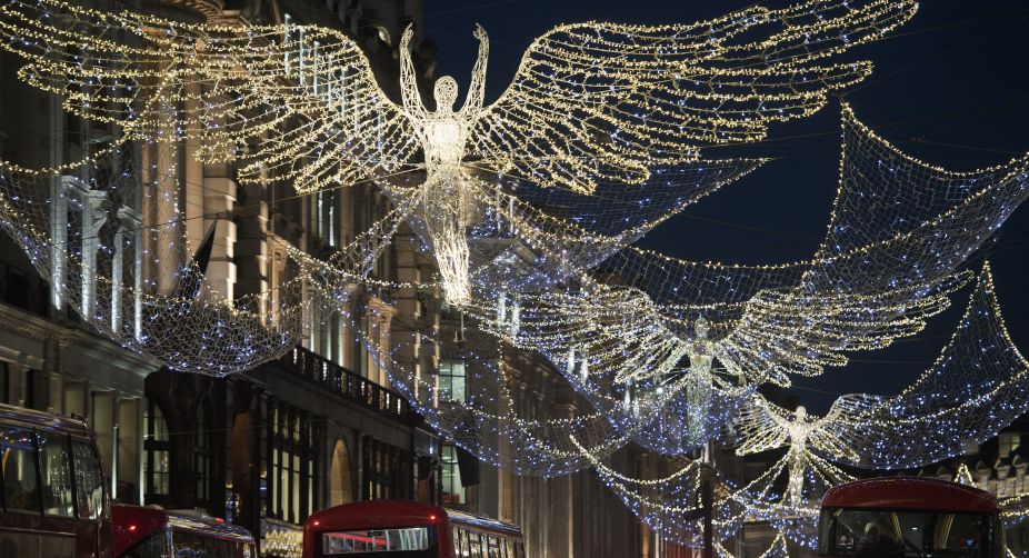 Red London busses pass beneath the Christmas festive lights on Regent Street in London (Photo: Justin Tallis/AFP) img