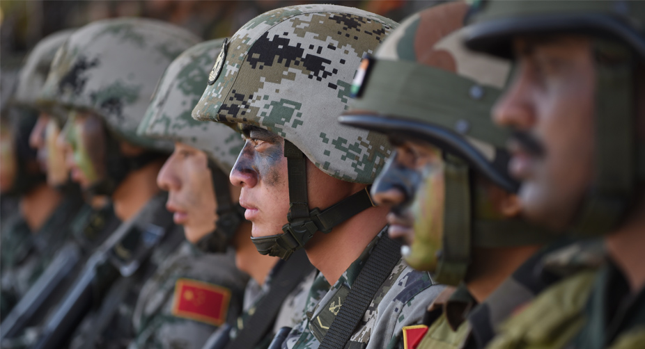 Many Faces, Same Aims: The People's Liberation Army (PLA) and the Indian Army line up for instructions prior to the anti-terror drill (Photo: Indranil Mukherjee/AFP) img