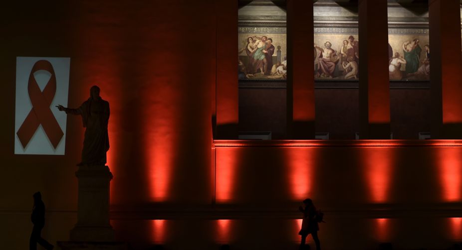 The National and Kapodistrian University of Athens is illuminated with a red light by the Hellenic Center for Disease Control & Prevention, on the eve of the World AIDS Day (Photo: Aris Messinis/AFP) img