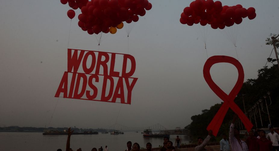 Indian social activists and children release a World AIDS Day awareness sign tied with ballons on the eve of the World Aids Day in Kolkata. According to the UN AIDS programme, India had the third-largest number of people living with HIV in the world at the end of 2013 and it accounts for more than half of all AIDS-related deaths in the Asia-Pacific region (Photo: Dibyangshu Sarkar/AFP) img