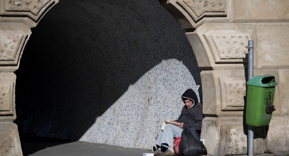 As the winter weather arrives into the European continent, a local homeless man reads his book under the oldest Hungarian bridge, the 'Lanchid' (the Chain Bridge) in Budapest (Photo: Attila Kisbenedek/AFP) img
