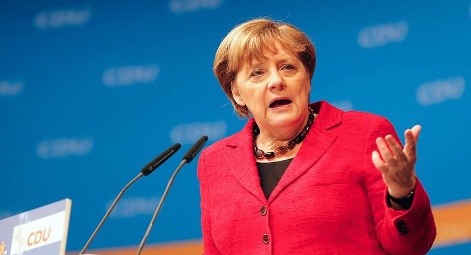 Merkel stresses Paris accord commitment, slams Trump