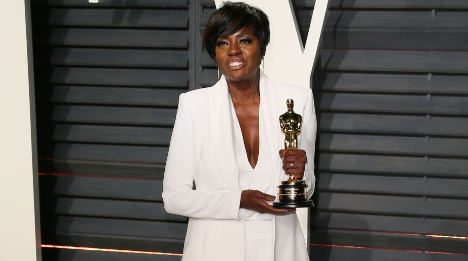 Actress Viola Davis, winner of the Best Supporting Actress award for 'Fences', poses with her Oscar at the party (Photo: AFP) img