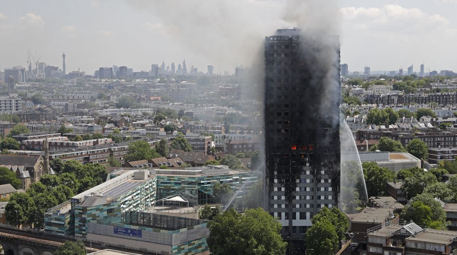 No immigration checks on London blaze survivors: May