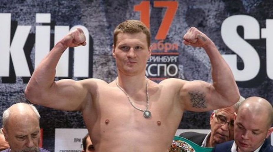 Boxer Alexander Povetkin wins twin heavyweight titles
