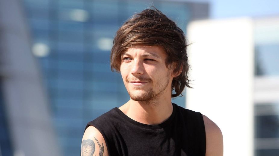 Tomlinson scolded by Cowell for getting drunk