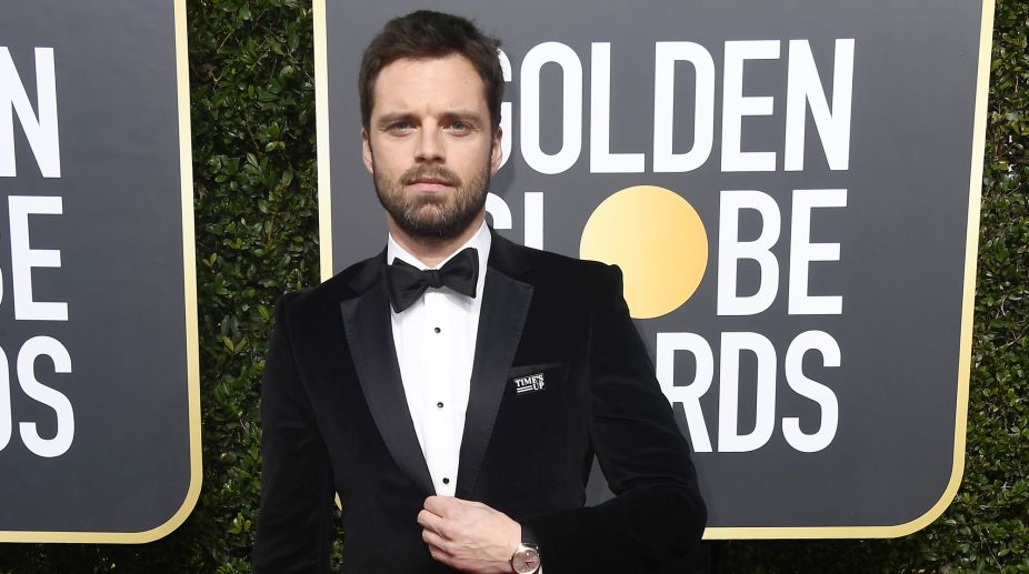 Sebastain Stan wore a black tuxedo at the event. Also he wore a tag of Time's UP, which shows his support for the movement (Photo Credits: AFP) img