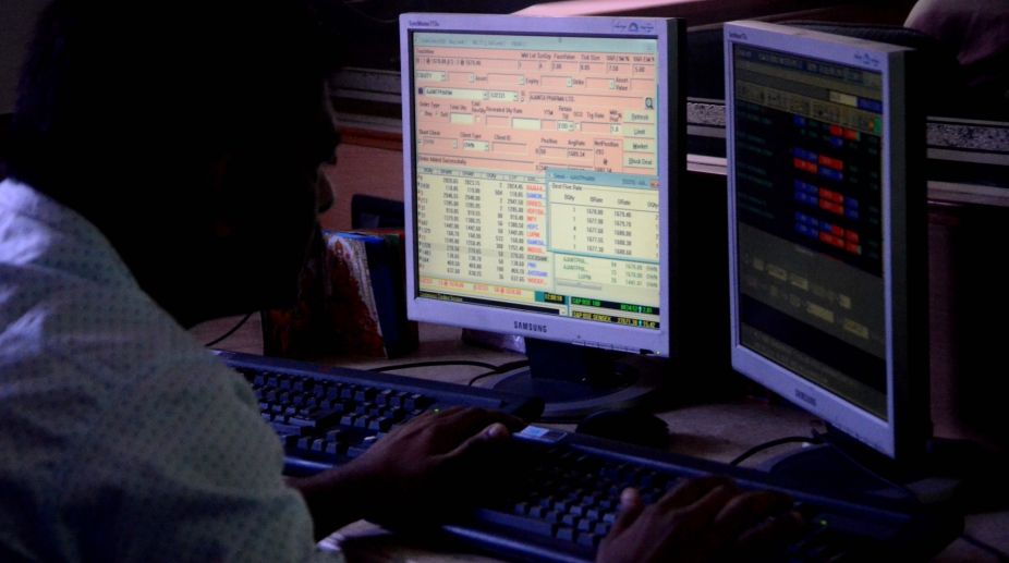 Mumbai: A share-broker looking at the share prices in Mumbai (Photo: IANS)