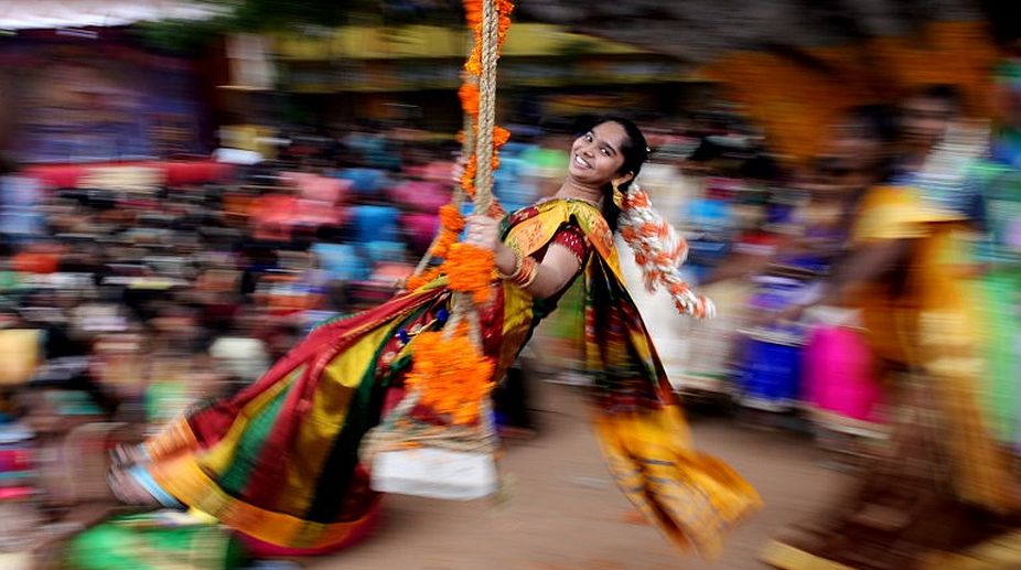 A student reacts on a swing during celebrations for Pongal, the Tamil harvest festival, at a college in Chennai on January 9, 2018. (Photo: AFP) img