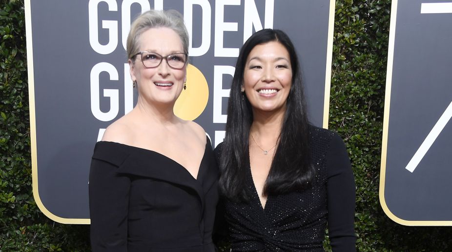 'The Iron Lady' aka Meryl Streep dressed in a black off shoulders poses for the shutterbugs alongside NDWA director Ai-jen Poo (Photo Credits: AFP) img