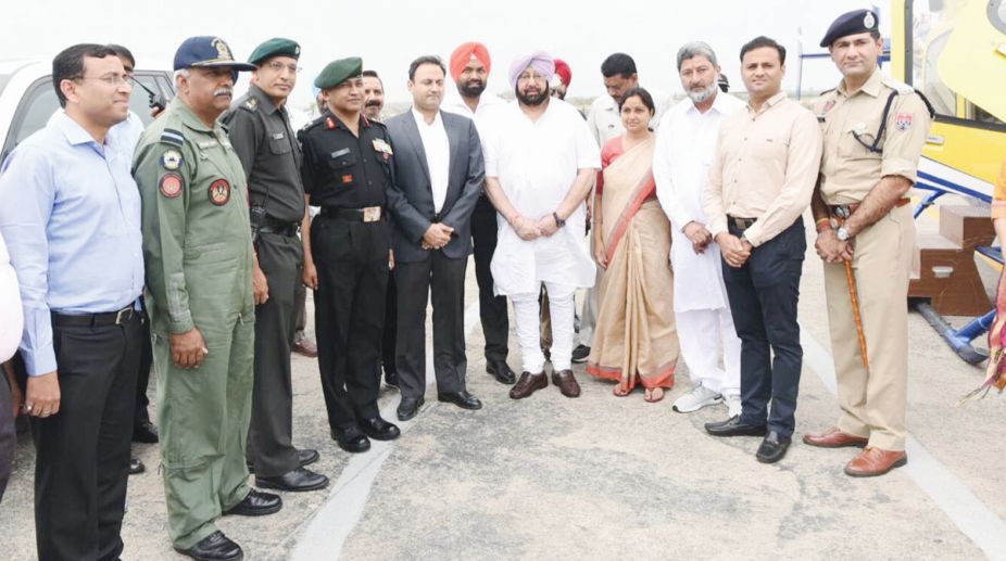 Punjab chief minister Amarinder Singh with officials and passengers, in Punjab on Thursday. (Photo: SNS)