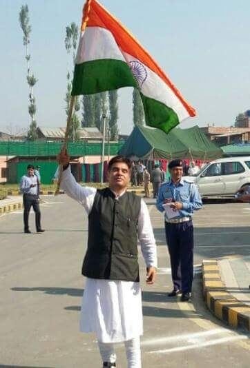Ravindra Raina with tricolour, New J-K BJP chief