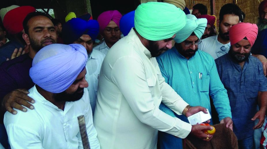 Punjab Local government minister Navjot Singh Sidhu, purchasing vegetables from striking farmers on Friday. (Photo: SNS)