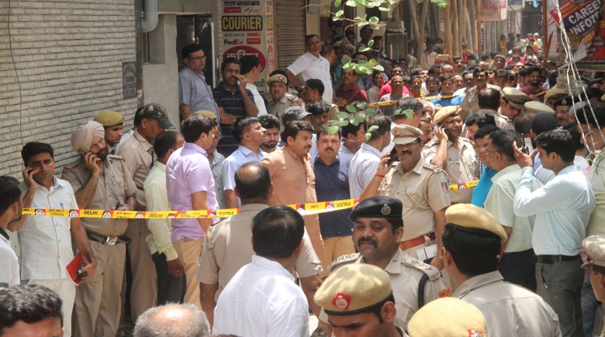 Delhi BJP chief Manoj Tiwari during his visit to the site where 11 members of a family were found dead -- some blindfolded and hanging from an iron grill ceiling -- at their home, in New Delhi on July 1, 2018. According to Joint Commissioner of Police Rajesh Khurana, while some bodies of them were found hanging from an iron grill ceiling (used as a ventilator) in the courtyard while others were lying on the floor blindfolded with their hands and legs tied at their two-storey house in Sant Nagar in Burari area. The bodies were sent for post mortem to ascertain the cause of deaths.
