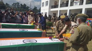 Wreaths being laid on coffins of 3 killed policemen