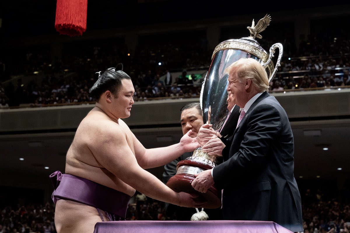 Trump gives trophy to sumo winner in Japan