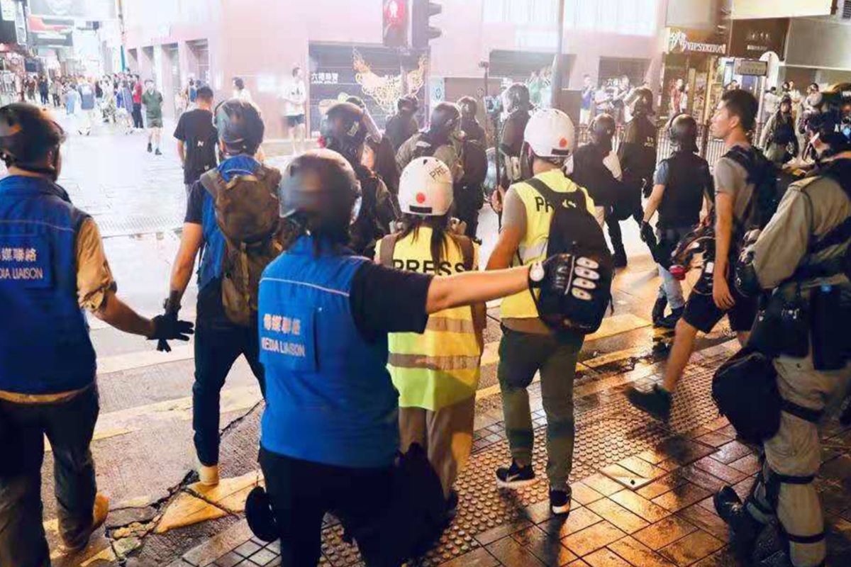 Hong Kong police fire tear gas at protesters in shopping district