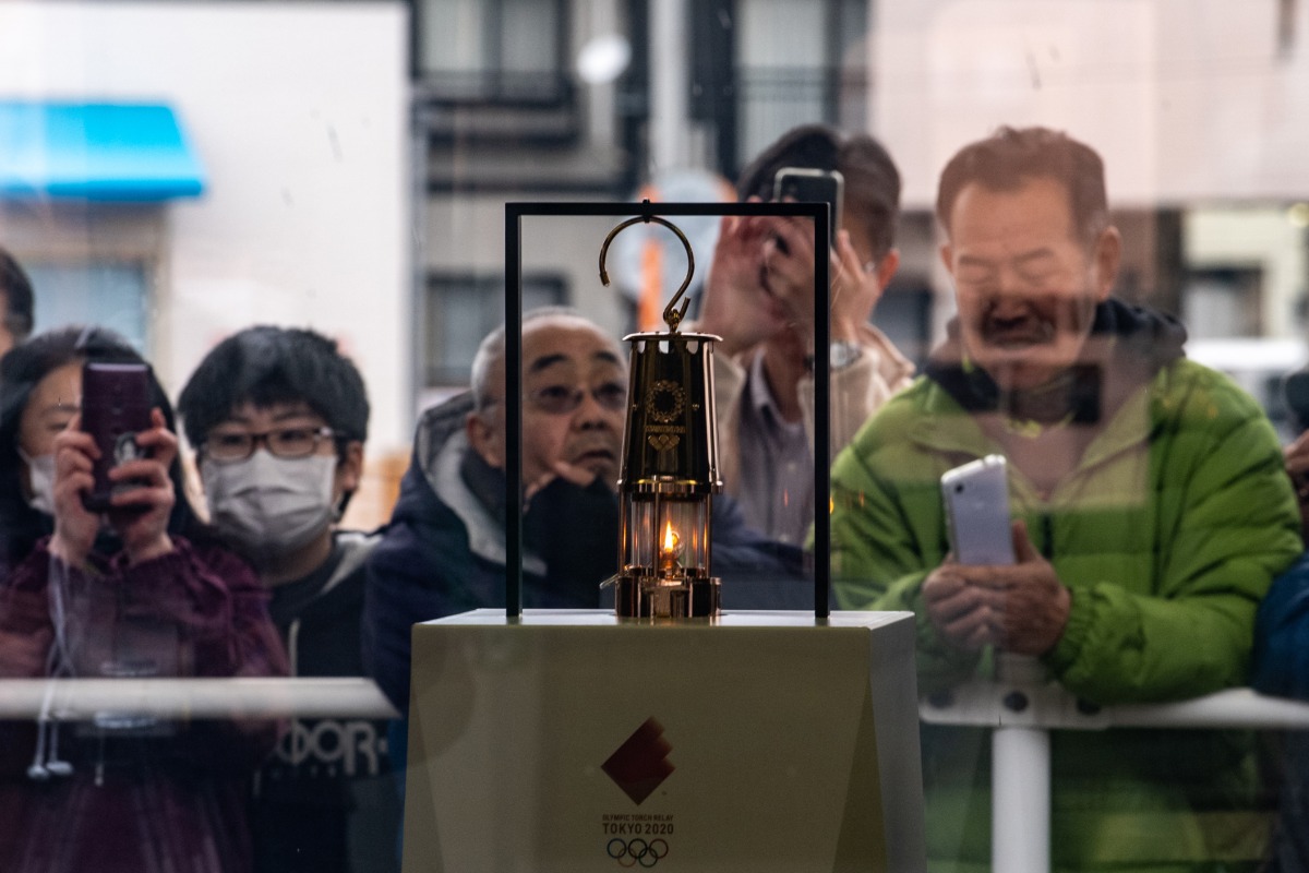 Thousands flock to see Olympic flame in Japan despite virus fears