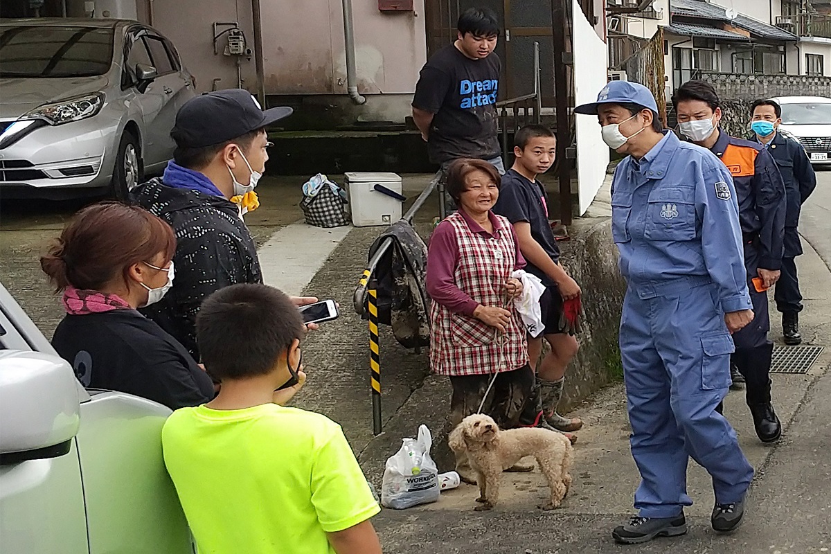 Japan PM Shinzo Abe visits flood-hit region, pledges financial support