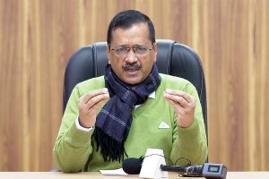 Kejriwal hands over cheques to farmers as compensation for crop loss