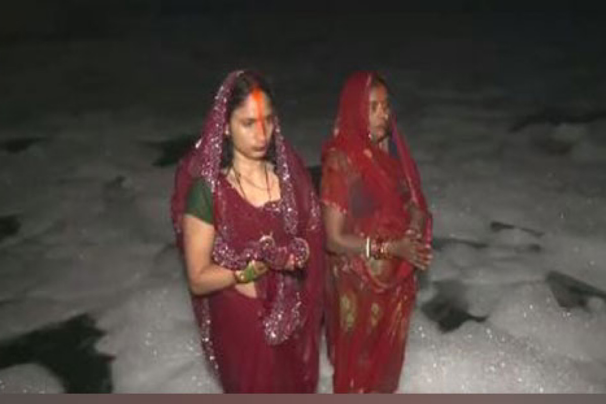 Delhi: Devotees stand in knee-deep toxic foam in Yamuna for Chhath Puja