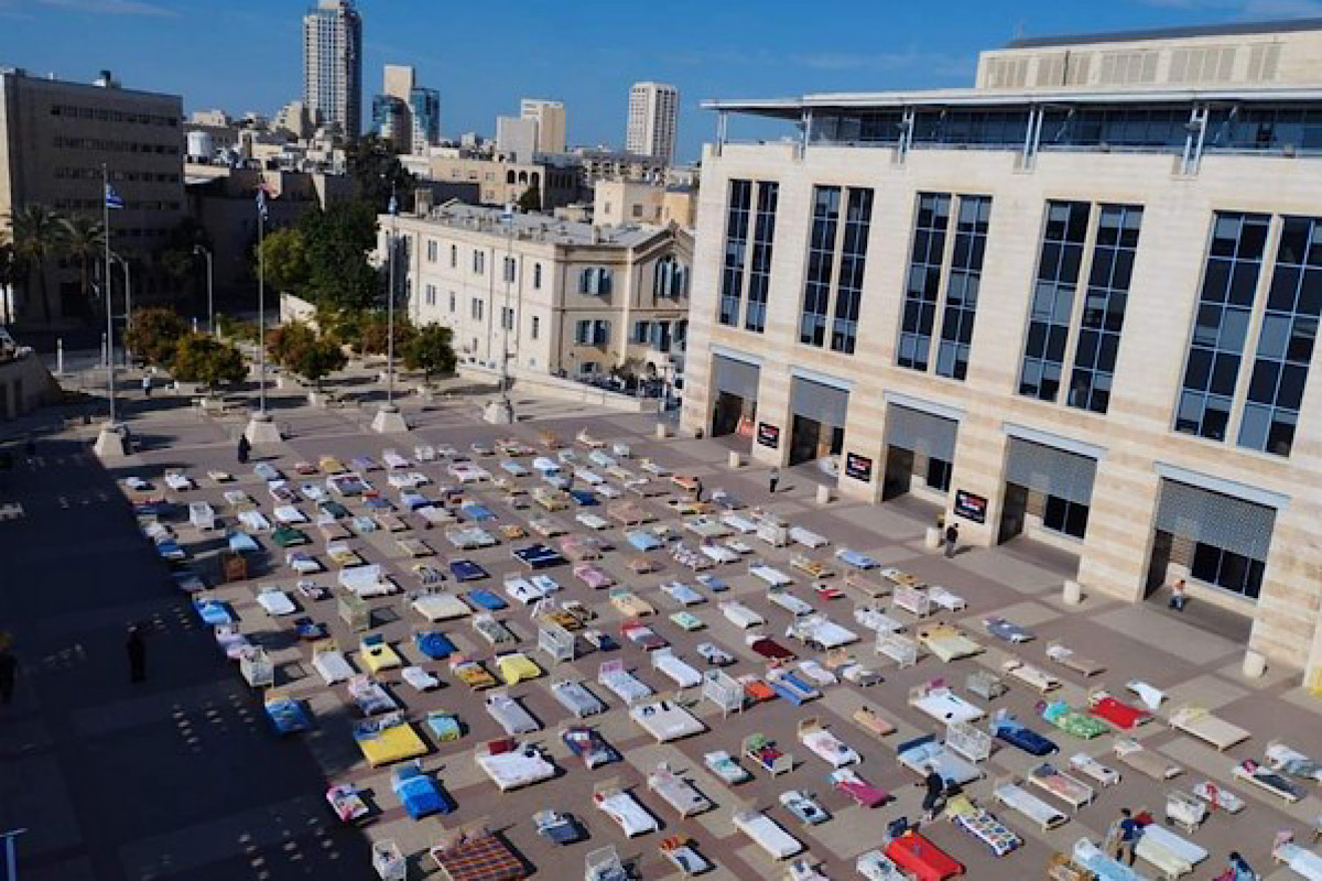Members of Kibbutz Nir Oz in Jerusalem set up 239 empty beds, symbolising Israeli hostages