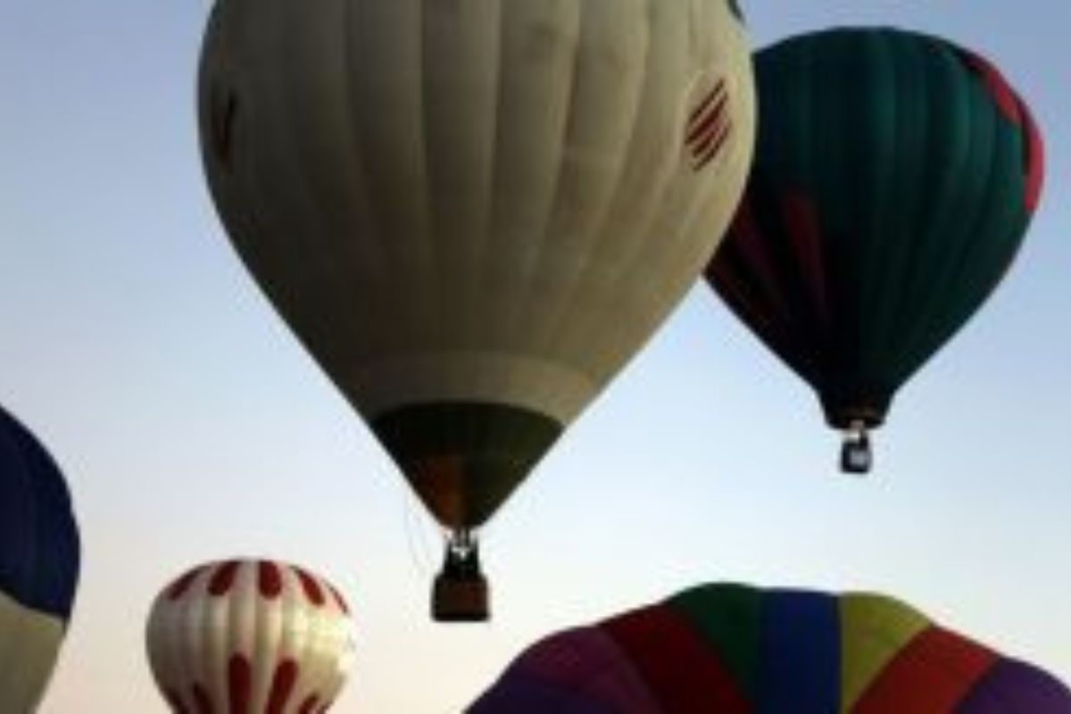Helium balloons urging electors to vote on 26 April dot Jammu skyline