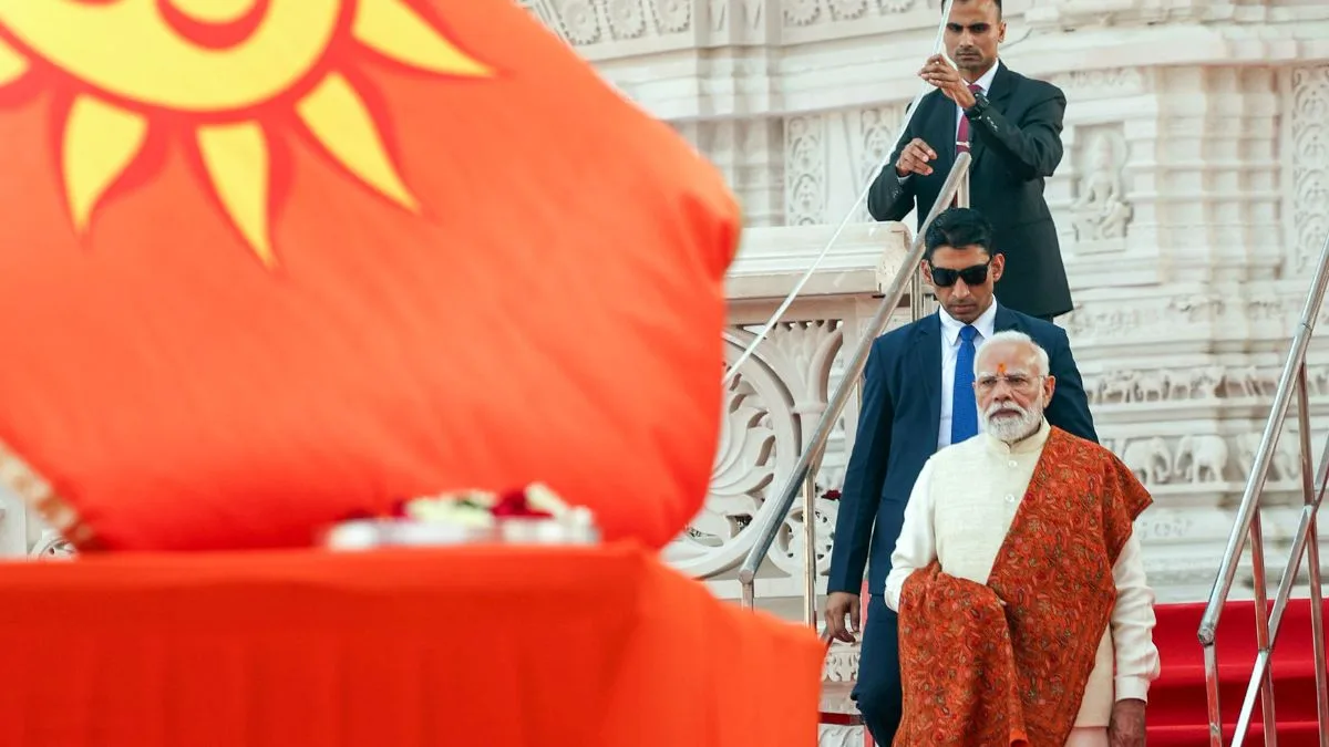 PM Narendra Modi stands barefoot near the saffron Dhwaj during the Ram Mandir ceremony in Ayodhya.