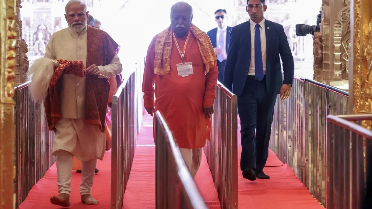 PM Modi and RSS Chief Mohan Bhagwat walk inside the Ram Mandir during the Dhwajarohan event.