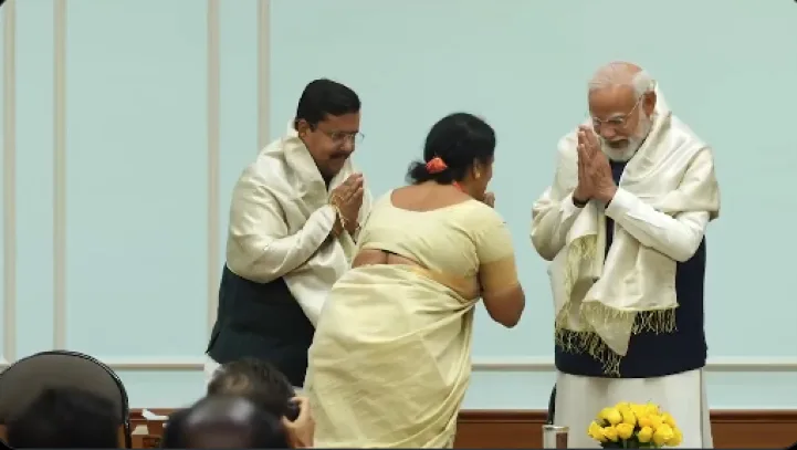 BJP National President Nitin Nabin stands alongside PM Modi as a woman party worker offers respectful greetings in a traditional namaste during the meeting’s proceedings. img