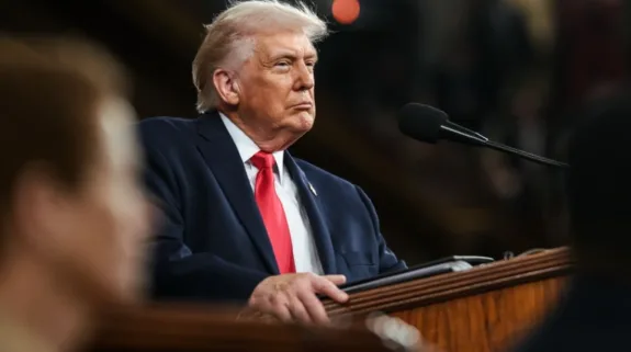 US President Donald Trump speaking at a podium during a public address
