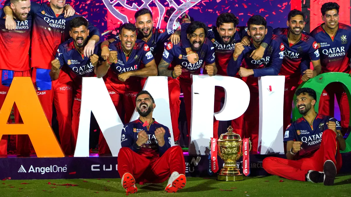 Royal Challengers Bengaluru players celebrate with the trophy after winning the Indian Premier League (IPL) 2025 final match against Punjab Kings, in Ahmedabad on Tuesday, June 3, 2025. (Photo: IANS)