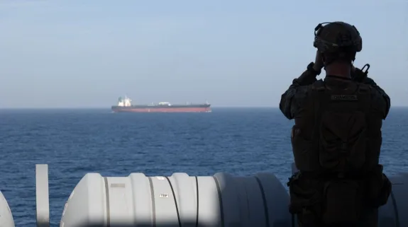 US Marine monitors cargo ship during Iran-US maritime tensions amid naval blockade operations