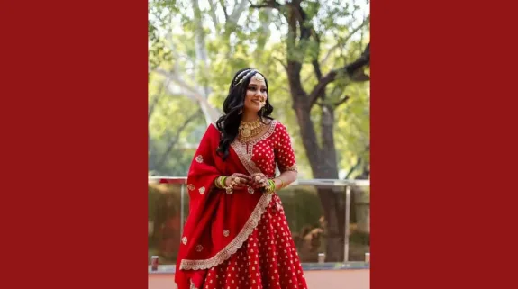 Twisha Sharma in traditional red bridal attire in a portrait photograph